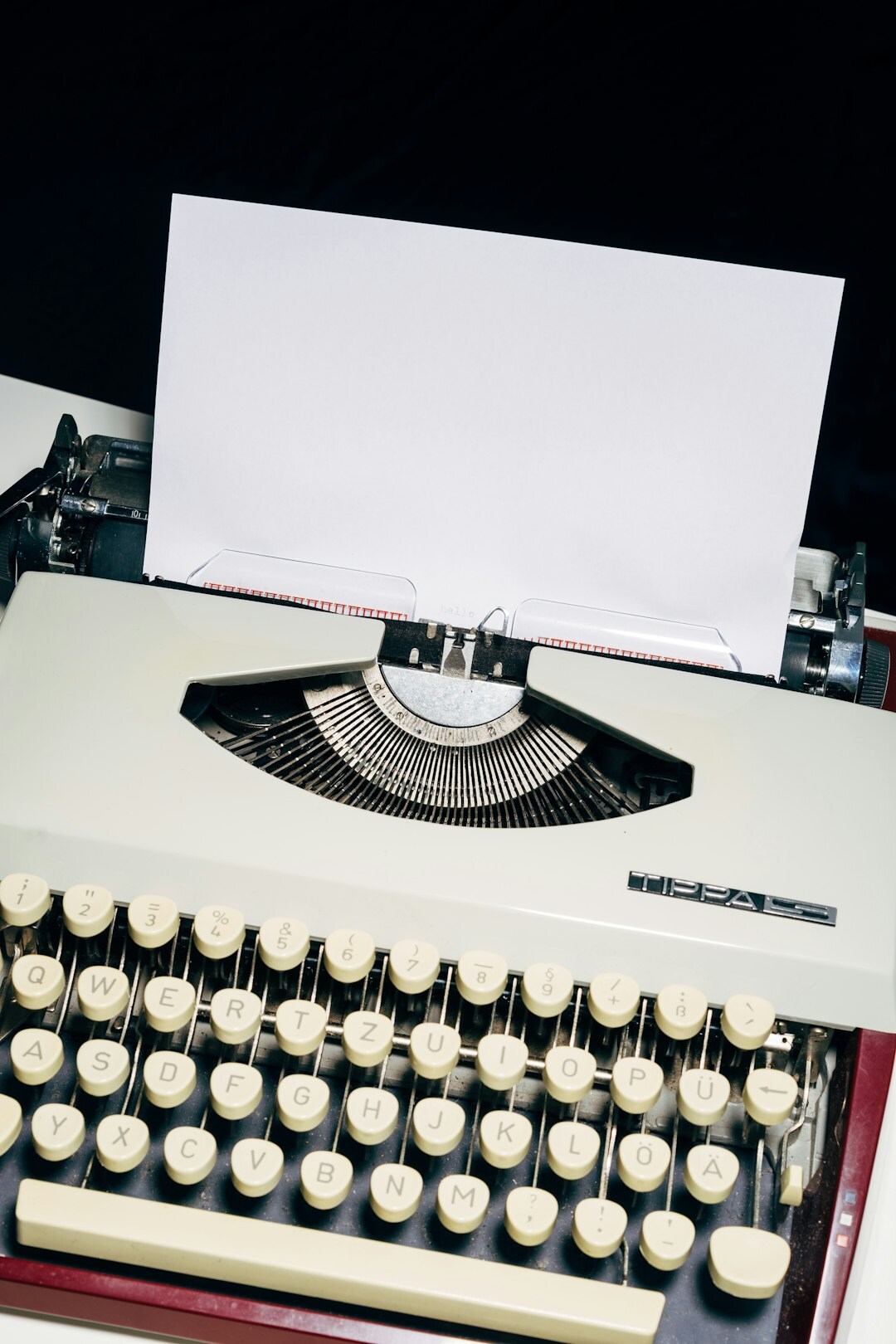 Vintage typewriter with a sheet of paper and a magnifying glass