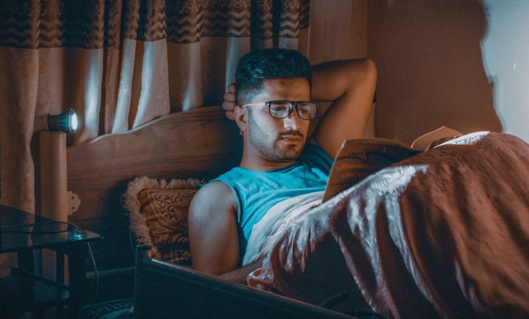 Uruguayan man reading a suspense novel under a lamp at night