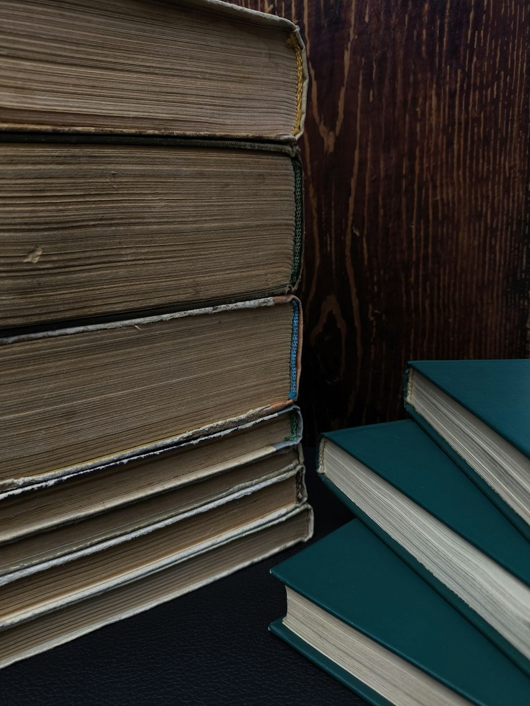 Stack of old detective and mystery novels on a wooden table